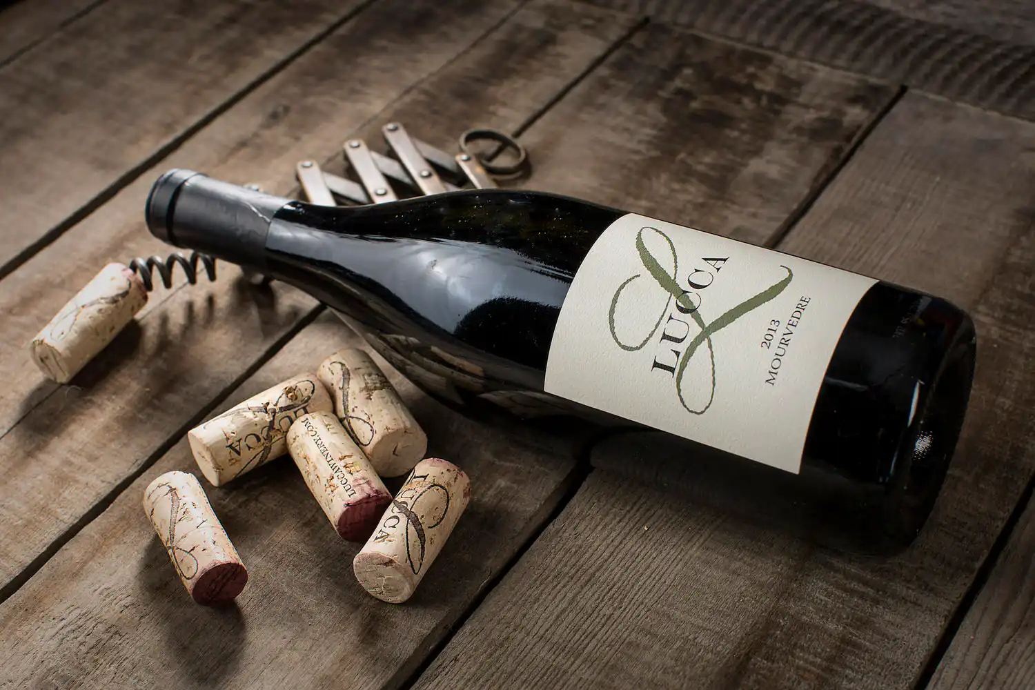 Lucca Winery — wine bottle and corks on old wood