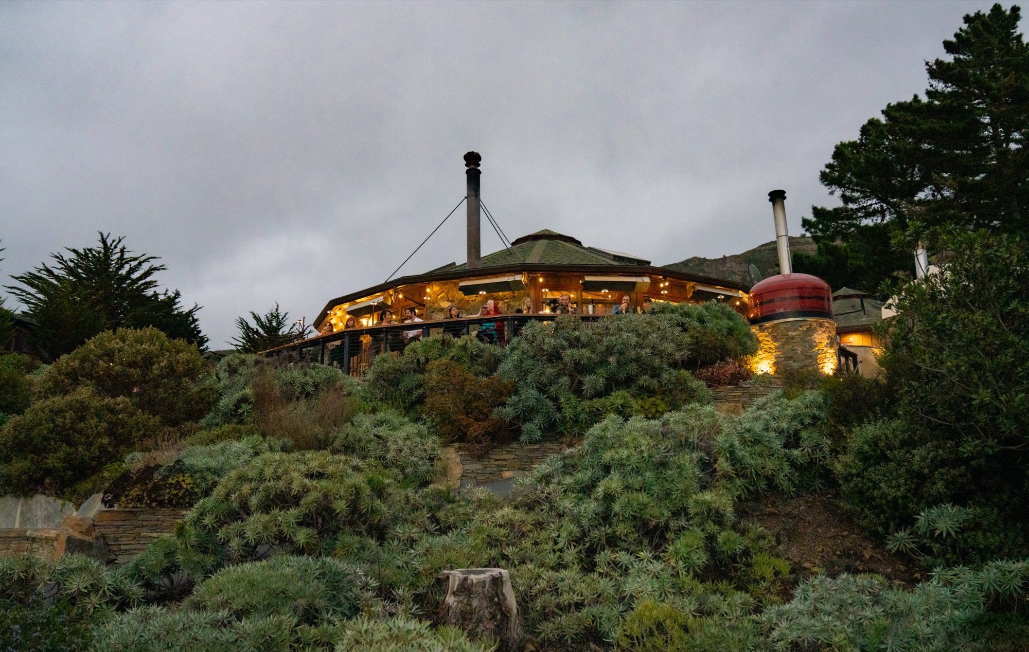 The Lodge Restaurant glowing at dusk on the Big Sur bluff