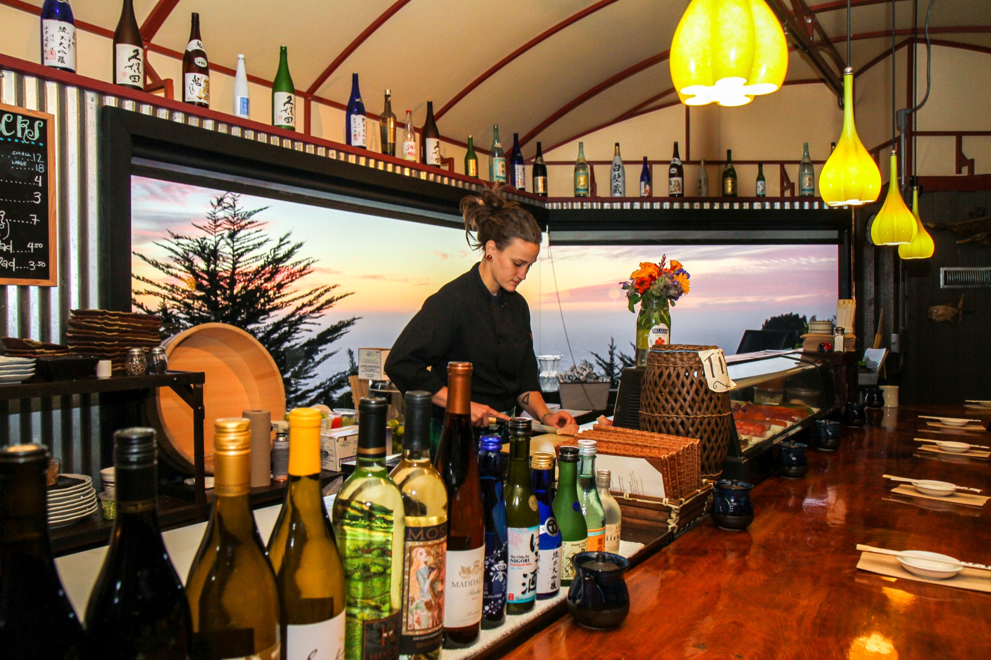 The Wild Coast Sushi bar at sunset, chef preparing omakase